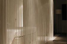 02 fringe curtains that are lit up are a perfect divider for modern and minimalist homes