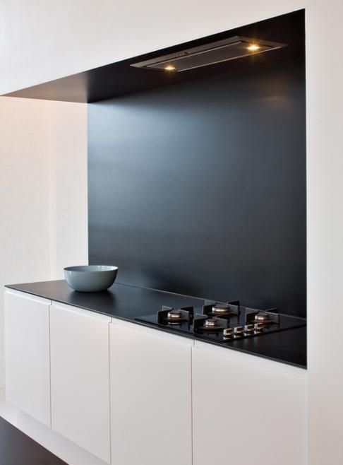 minimal kitchen with contrasting accents and built-in cabinets for a sleek clean look