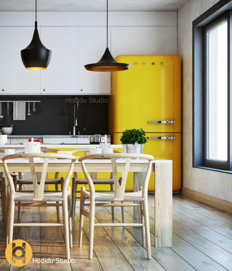 A yellow fridge and cabinets stand out from white cabinets and a black chalkboard backsplash