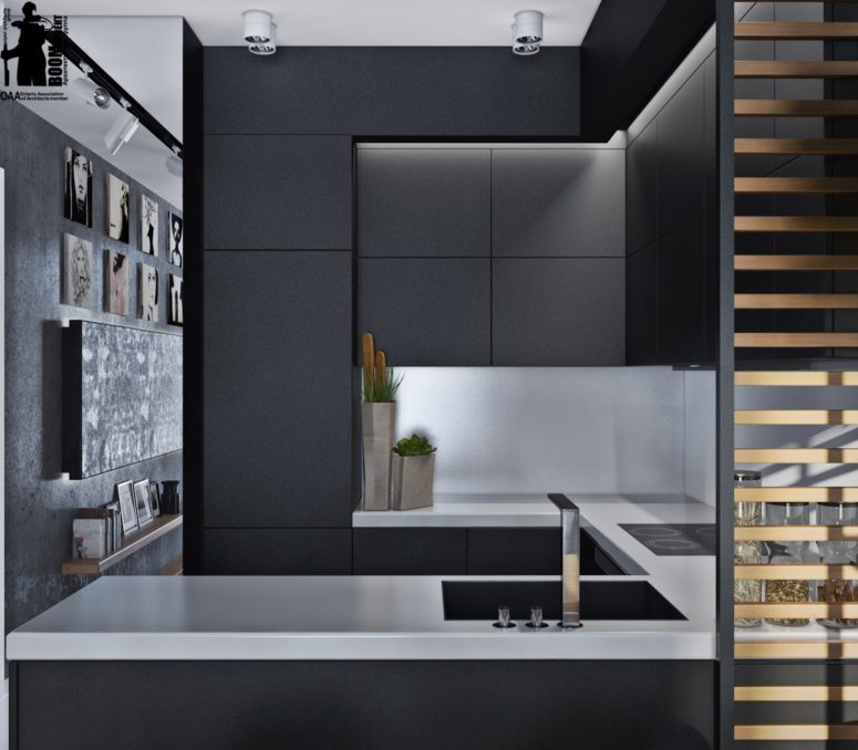 The kitchen itself is a small nook with matte black cabinets and white countertops