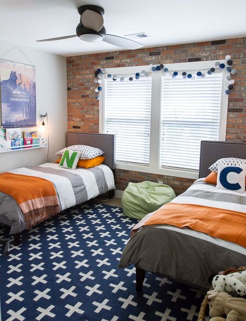 exposed brick wall is a perfect fit for a boys' bedroom
