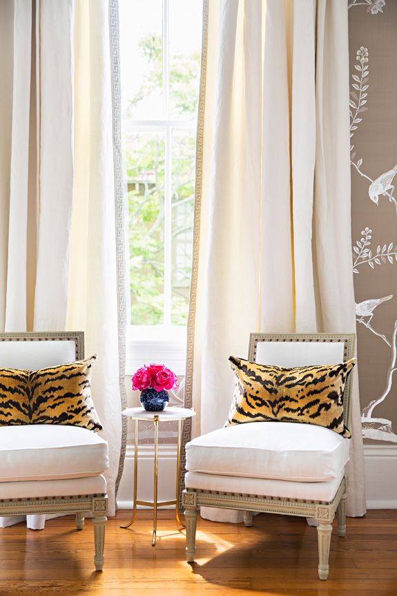 Antique chairs contrast with animal print cushions