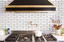 04 The hood and cooker are art deco, in black and gold. Masterpieces are created here