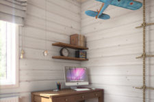 04 The study nook boasts of a small simple desk, open shelving and a vintage blue plane hanging over it