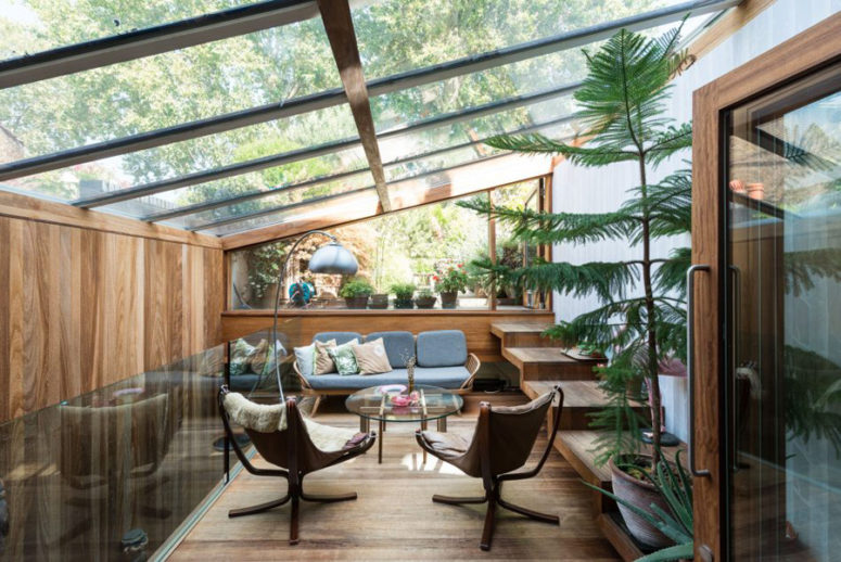 This is a glazed terrace with greenery added as an extension, it's a secluded place for a rest