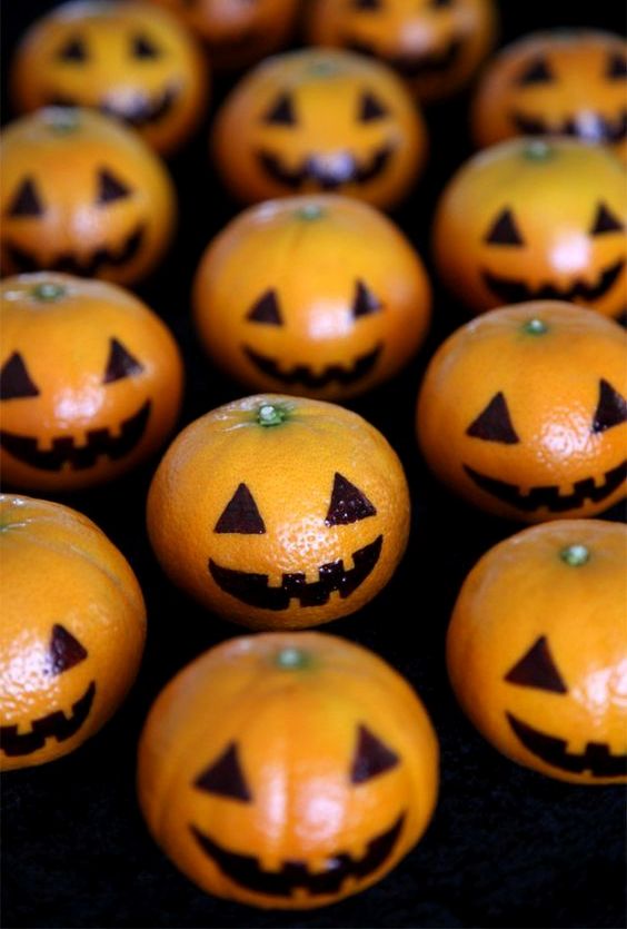 Mandarins decorated as pumpkin jack o lanterns will excite your guests