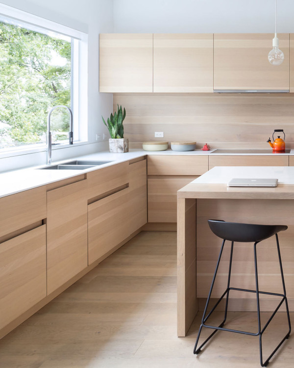 The kitchen is minimalist and is clad with white oak as the floors in the house