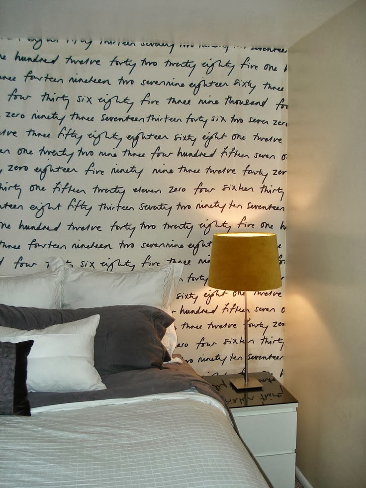 fabric handwriting accent wall doubles as a headboard in this bedroom
