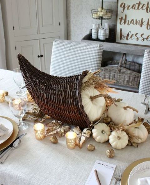woven cornucopia with white pumpkins and gilded nuts