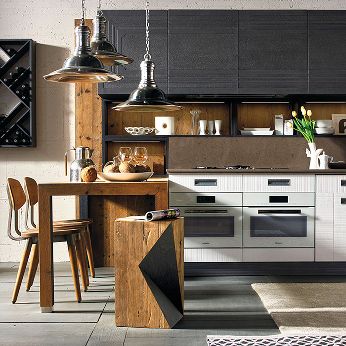 Aging wood and dark metal contrast and make the kitchen original