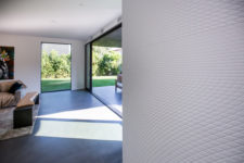 06 Inside walls and floors are covered with textural finishes that echo with the creative outer decor and architecture