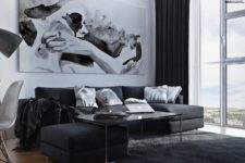 06 The living space has a large sectional sofa, an oversized artwork and floor to ceiling windows