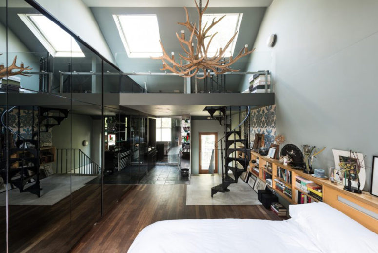 The stunning master bedroom has double-height ceilings, an en-suite bathroom and a cool staircase