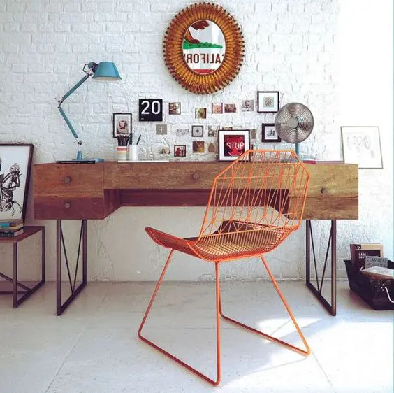 Mid century modern home office with a boho flavor is complemented with a white brick wall