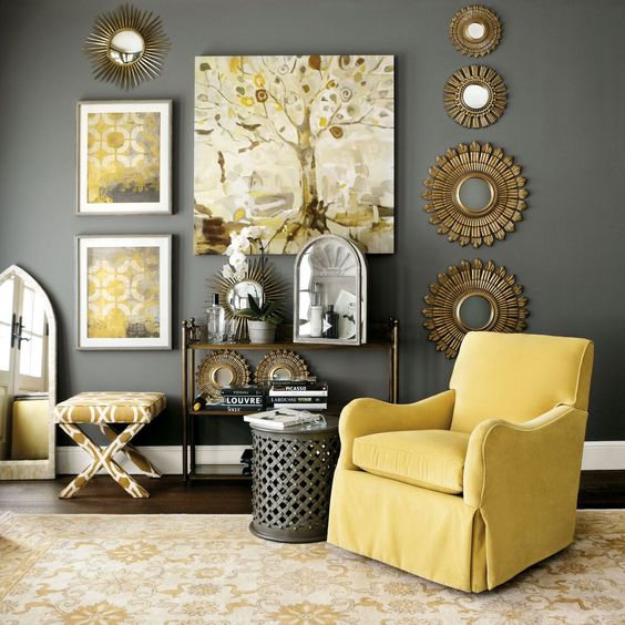 rather dark grey wall and a side table, sunny yellow armchair, artworks and a printed chair
