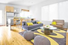 07 airy living room with grey and yellow details looks very cheerful, and yellowish wooden floors add a sunny touch