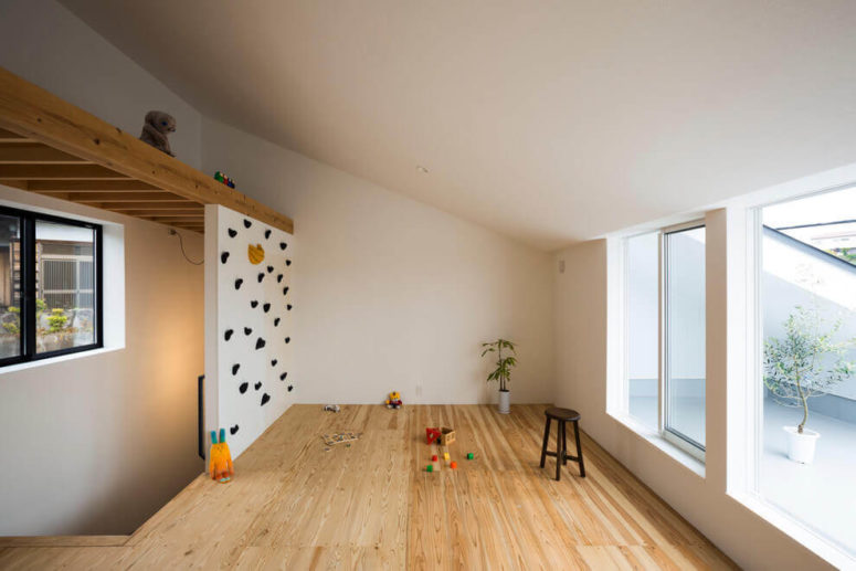 A small kids' play space is opened to a private courtyard, and there's a sliding door or window to go there