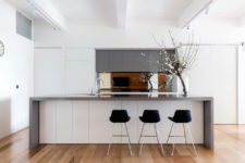 08 The minimalist kitchen is done in white and grey, it’s clear and uncluttered