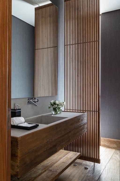 wooden panel that lets light in and helps the bathroom look like a spa thanks to the natural wood texture