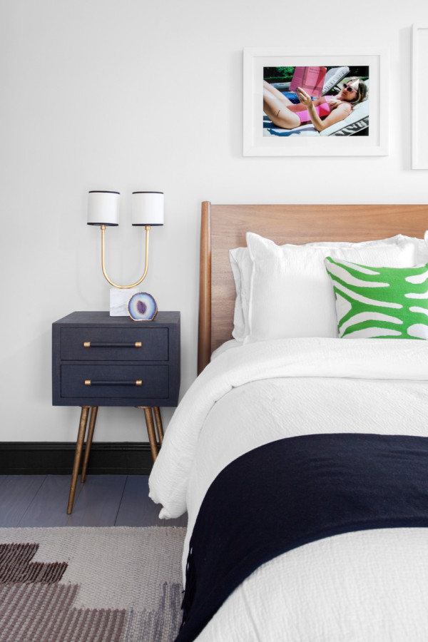 Small nightstands are mid-century modern, with gold touches and legs
