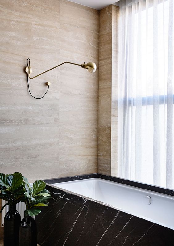 Stone and marble of various shades make this bathroom cool and refined