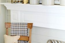 09 neutral fall mantel incorporating farmhouse style with vintage wooden chair, tobacco baskets, and burlap pillows