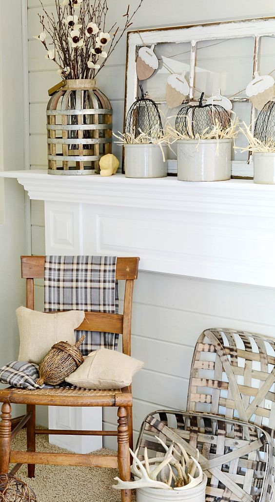 neutral fall mantel incorporating farmhouse style with vintage wooden chair, tobacco baskets, and burlap pillows