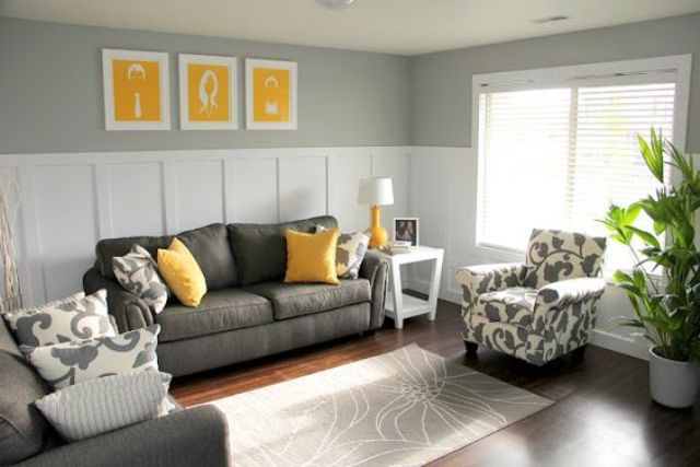 charcoal grey sofa and chair, yellow pillows and art pieces