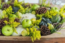 11 seasonal pumpkins, gourds, pinecones and flowering branches in a wooden bowl