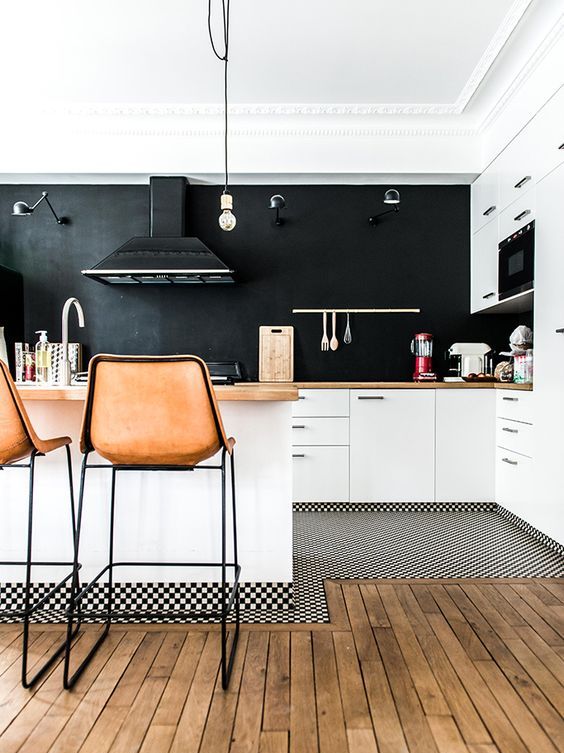 in this kitchen only walls and a backsplash are black, it makes the kitchen more airy and inviting