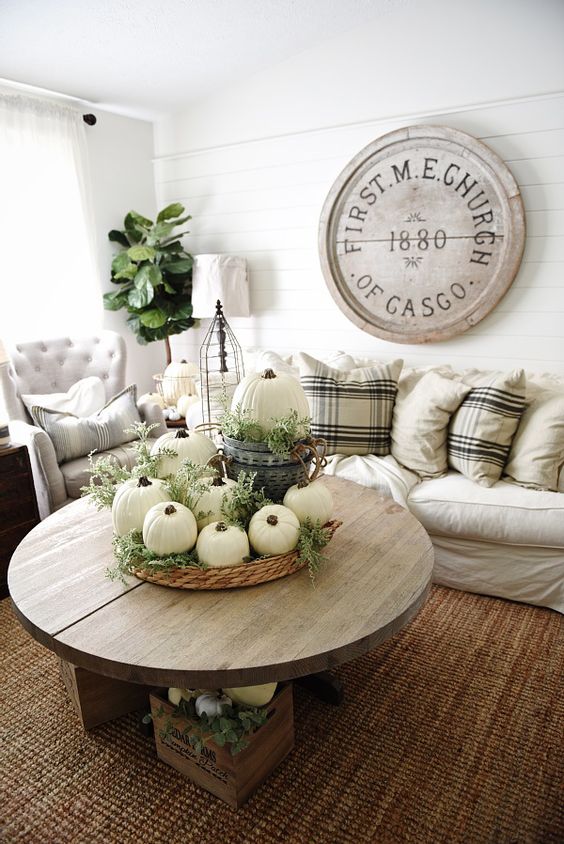 neutral decor with pumkins and greenery will bring a fall feel to the space