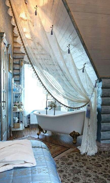 bathtubs in attic bedrooms are a hot trend, and a tulle curtain can easily divide these two spaces