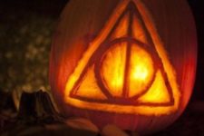 14 Deathly Hallows symbol from the Harry Potter series carved on a pumpkin