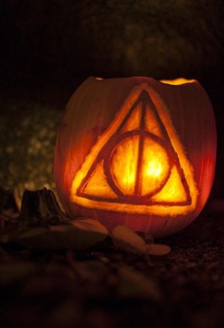 Deathly Hallows symbol from the Harry Potter series carved on a pumpkin