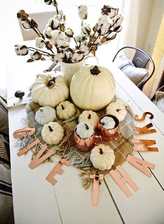 pops of copper and neutral pumpkins mixed with plaid and cotton make a lovely centerpiece