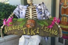 15 tropically dressed skeleton with a sign