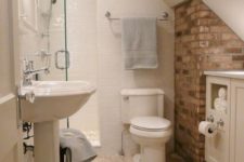 16 a piece of brick wall adds to the simple decor of this bathroom