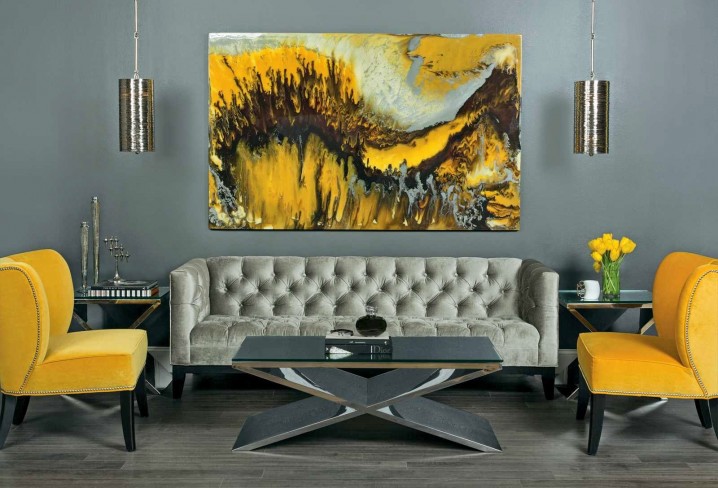 refined living room in grey shades looks bolder with yellow chairs and a painting