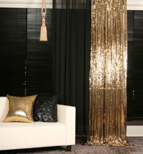these black and gold sequin curtains add a bold touch to the room decor