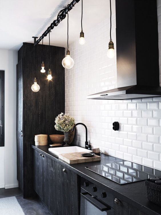 white subway tiles and black wooden cabinets give this kitchen a textural look