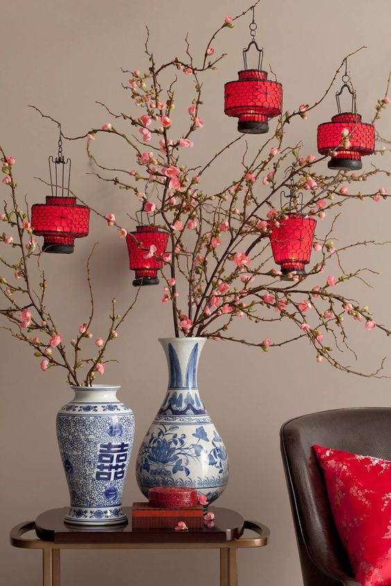 Cherry blossom branches with red paper lanterns