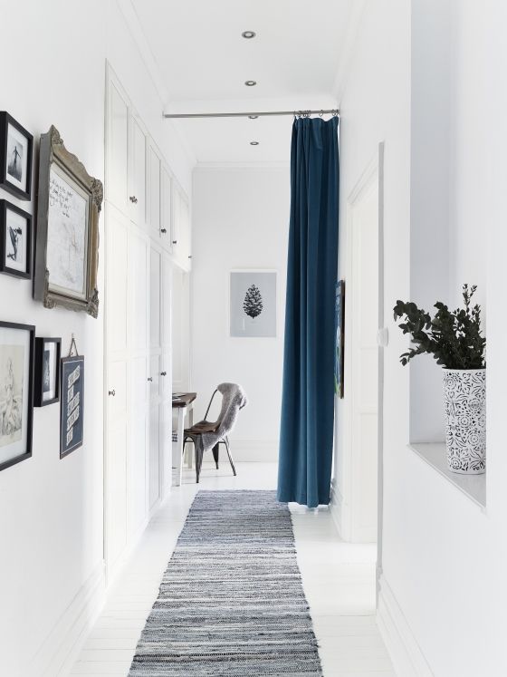 this blue curtain is used instead of a door to separate the dining room from the hallway