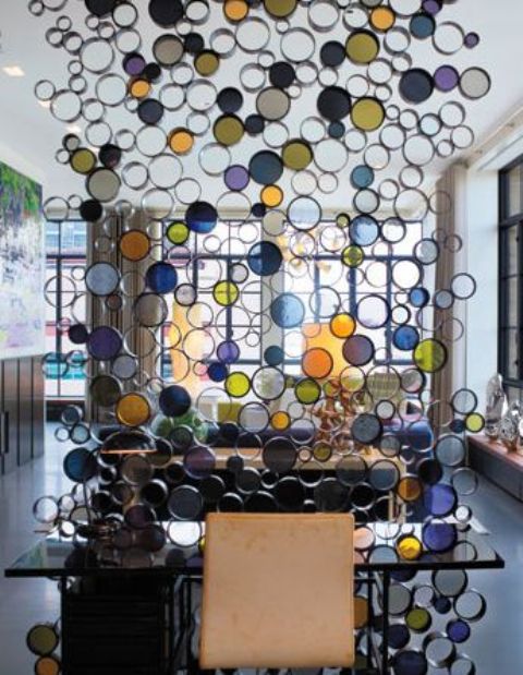 colorful glass room divider creates a fun and cheerful touch to the decor of the space