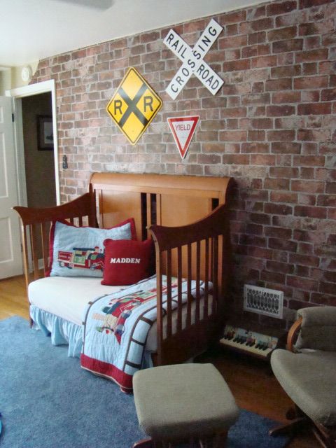 Train inspired boy's room looks great with an exposed brick wall