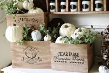 19 vintage crates with white pumpkins and greenery