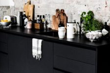 21 black cabinets and white bricks to add a textural look to the kitchen
