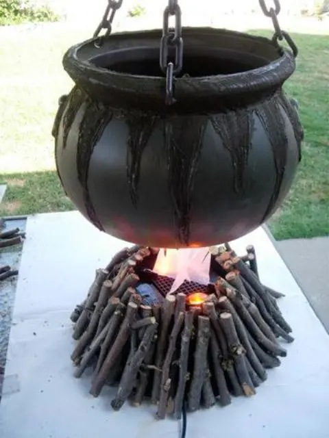 cauldron with sticks for outdoor Halloween decor