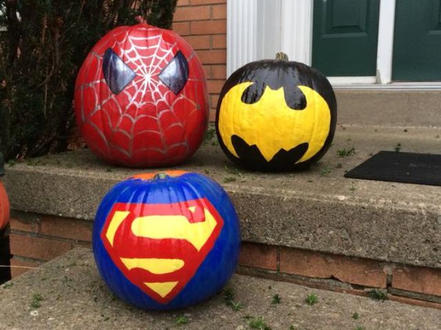 painted Batman, Superman and Spiderman pumpkins for outdoor decor