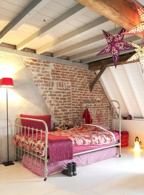 attic girl's space with a part brick wall that makes a statement