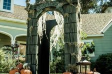 22 crypt gateway decorated with pumpkins, skulls, lanterns and spiderweb